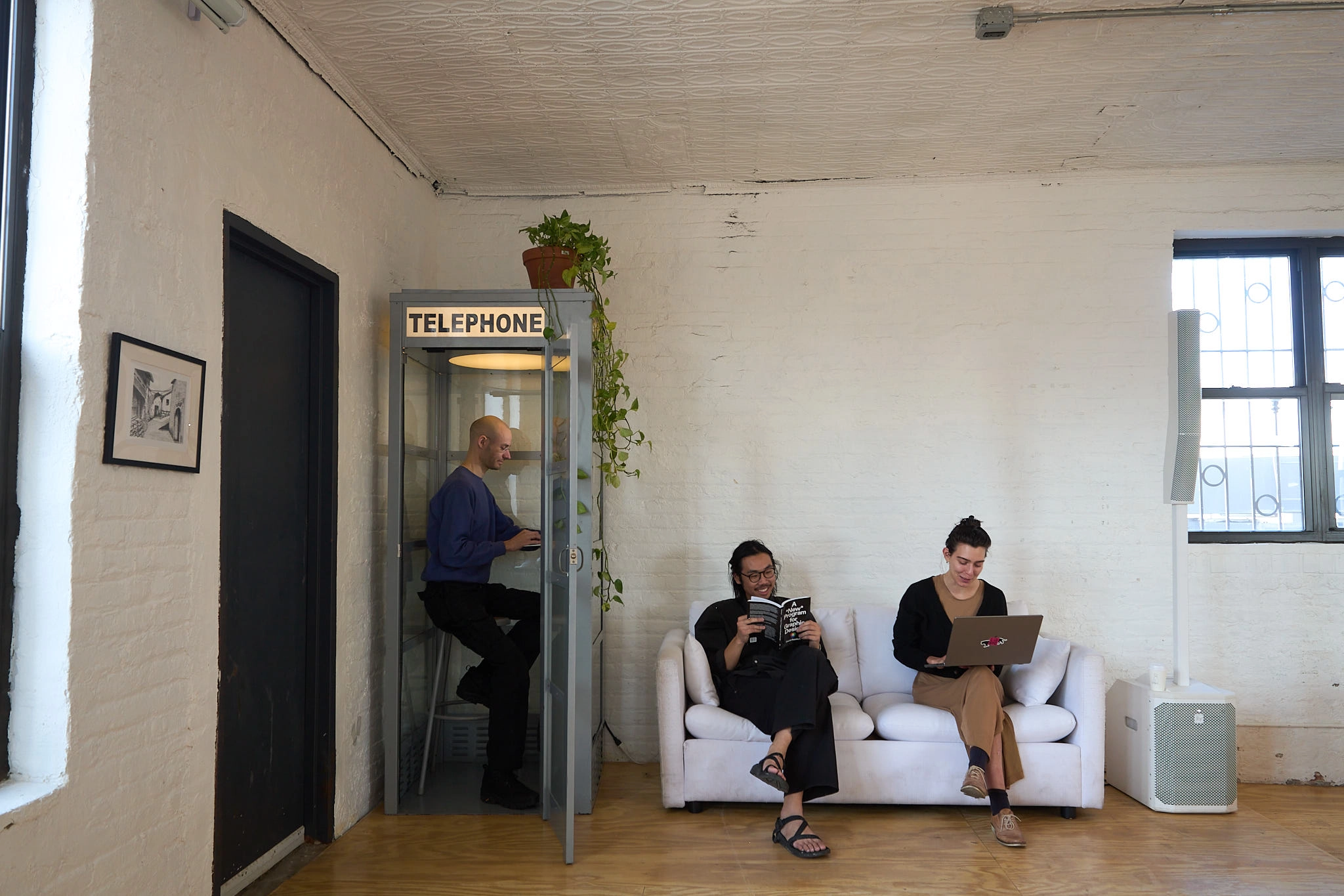 A spread of different audio equipment and colored pencils on a white tablecloth.